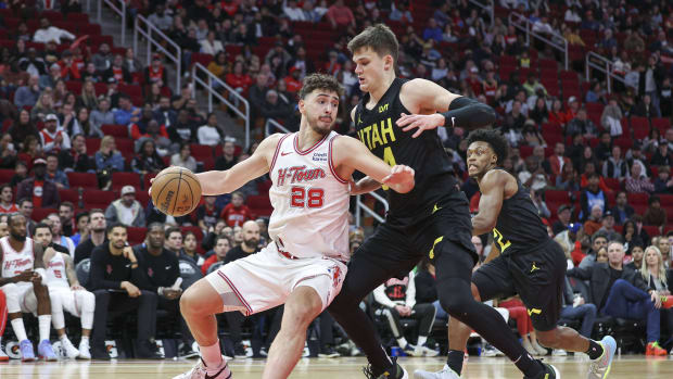 Jan 20, 2024; Houston, Texas, USA; Houston Rockets center Alperen Sengun (28) controls the ball as Utah Jazz center Walker Kessler (24) defends during the fourth quarter at Toyota Center. 